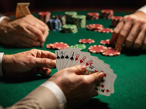 Three face-down cards and chips on a live Teen Patti table with a dealer behind
